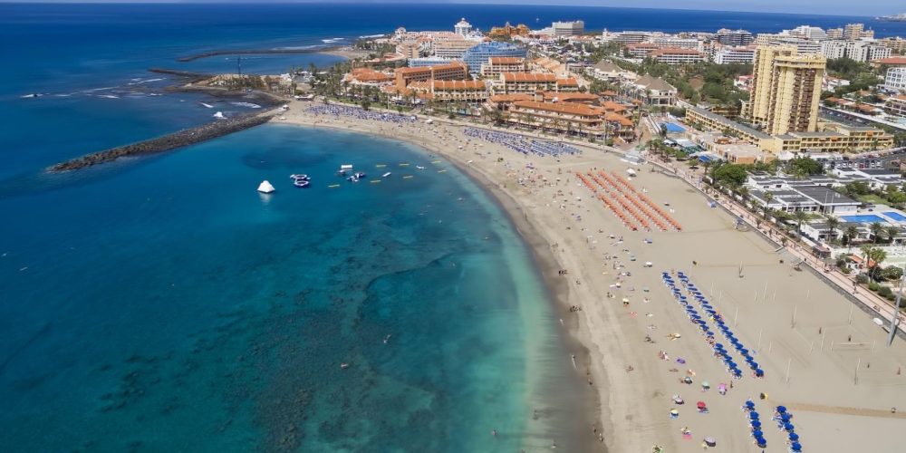 Foto desde el aire de la Playa de las Américas donde se puede ver el color claro de las aguas y el color marrón claro de la arena